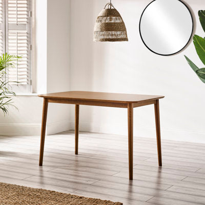 Solid wood farmhouse dining table with splayed legs and trestle base